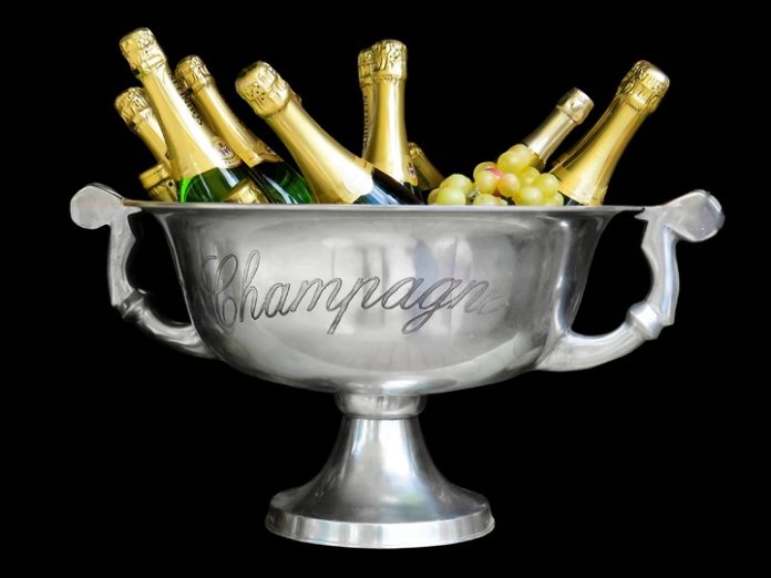 An ice bucket filled with champagne bottles