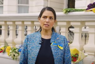 Image shows home secretary Priti Patel wearing a blue and yellow ribbon on her jacket for Ukraine.