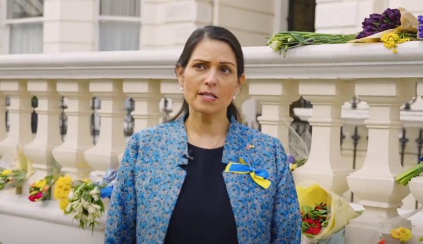 Image shows home secretary Priti Patel wearing a blue and yellow ribbon on her jacket for Ukraine.
